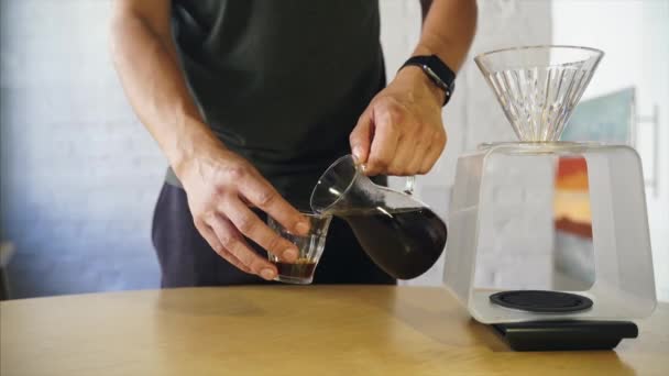 Barista gießt Kaffee in Glasbecher — Stockvideo