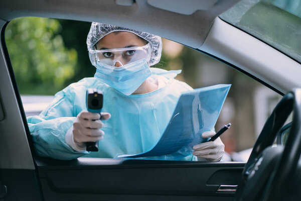 Doctor woman use infrared thermometer gun to check body temperature