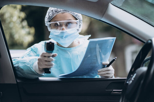 Doctor woman use infrared thermometer gun to check body temperature