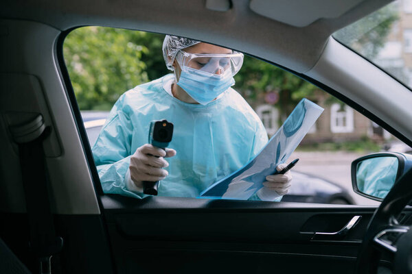 Doctor woman use infrared thermometer gun to check body temperature