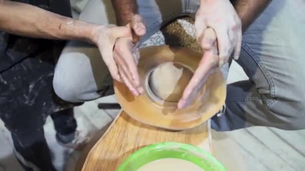 Making a handmade clay pot in the workshop. Pottery lesson with master. — Stock Video