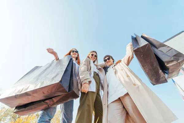 stock image Young women with bags in hands posing for the camera