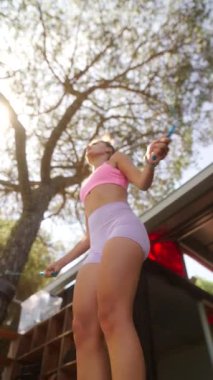 Canlı bir insan heyecan verici bir ip atlama egzersizinden, güneşli havada zindelik ve zindelik göstermekten hoşlanır.