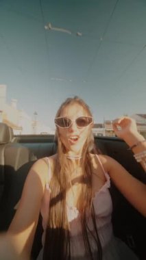 Güneşin altında üstü açık bir arabada geçirilen kaygısız ve neşeli bir an. Yazı ve arkadaşlığı kutluyoruz.