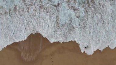 Sersemletici bir hava manzarası sahili usulca yıkayan sakin dalgaları yakalar ve sahillerin sükunetini ön plana çıkarır.