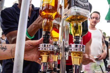 Bottles of whiskey for sale and consumption at the LGBTQIA+ Pride Parade in Goiania.