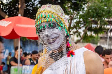 A man in costume, with his face painted white, at the LGBTQIA+ Pride Parade in the city of Goiania.