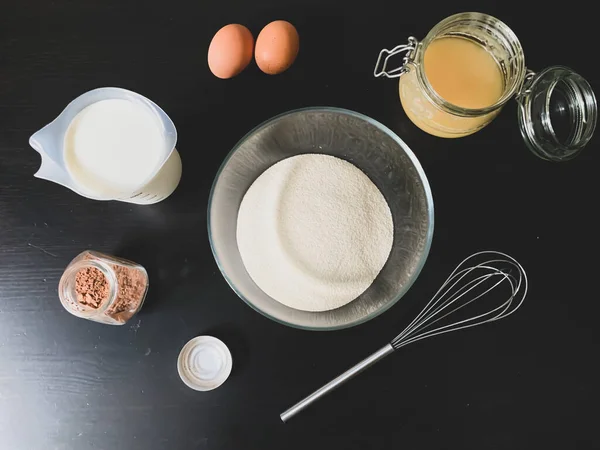 Process Preparing Dessert Black Wooden Table Flour Eggs Milk Honey — Stock Photo, Image