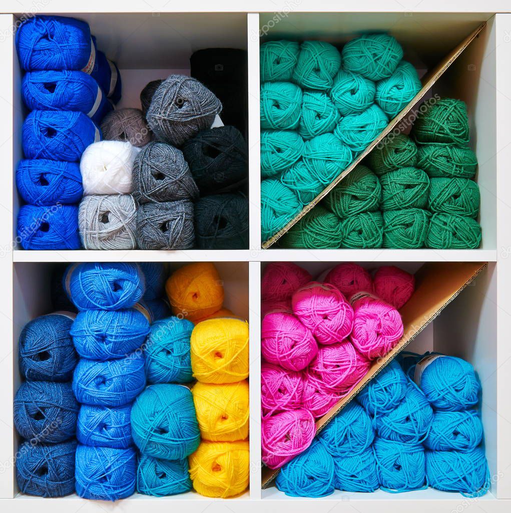 Some colorful balls of wool on a shelf