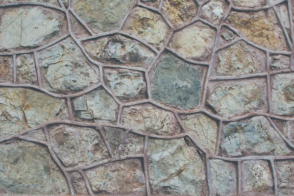 Gri ve kırmızımsı taş duvar. Antika taş duvar