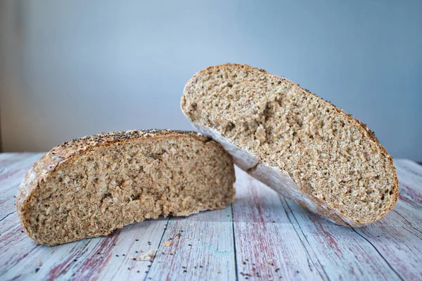 Chia tohumlu tam teşekküllü ekmek. Yuvarlak ekmek beyaz arkaplan ile ikiye bölünmüş