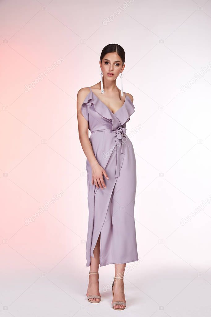 Pretty beautiful sexy elegance woman skin tan body fashion model glamor pose wear silk lilac dress casual clothes party summer collection makeup hair style brunette success accessory jewelry studio.