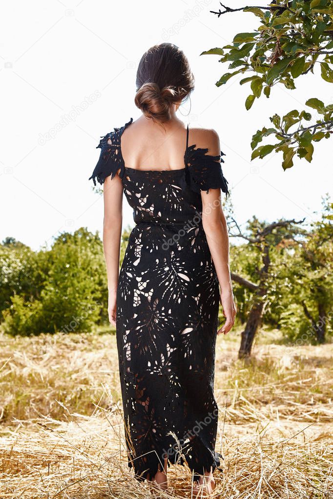 Beautiful young sexy woman long hair bright makeup nature background landscape dry spike grass and trees garden summer model dressed in black lace dress accessory apple romantic date sun sine.