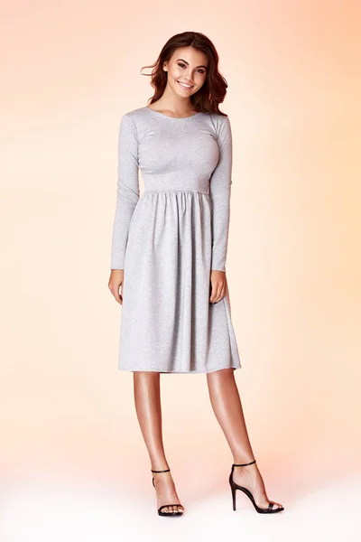 Beauty woman model wear stylish design trend clothing natural organic wool cotton grey dress casual formal office style for work meeting walk party brunette hair makeup.