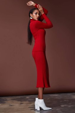 Esmer güzel kadın seksi sıska vücut şekli tan cilt bakım giyim moda elbise kırmızı renk pist modeli katalog giyim stil stüdyo bahar yürüyüş tarihi parti makyaj takı ayakkabıları için yüz.