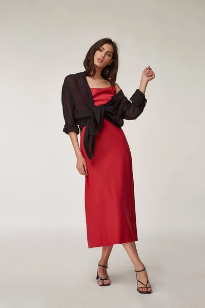 Fashion pretty woman beautiful makeup perfect body shape tanned skin wear clothes summer collection organic textile black cotton shirt, red silk dress stylish sandals shoes, accessory casual romantic.