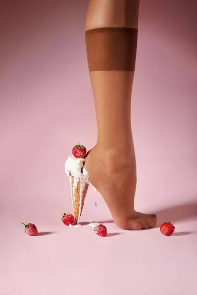 Nylons, stay-up, tights, hosiery, hose, pantyhose socks summer collection on pink background as a heel creative dessert ice cream with berry strawberry.