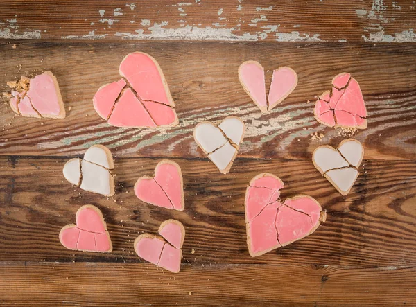 Array of Broken Heart Cookies over vintage wooden background