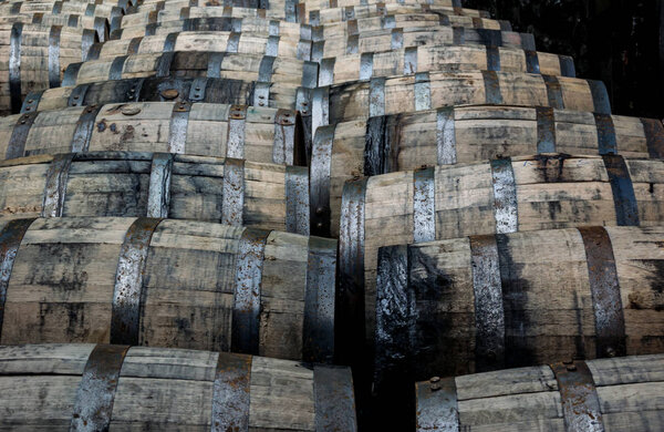 Bourbon barrels on their side in a distillery