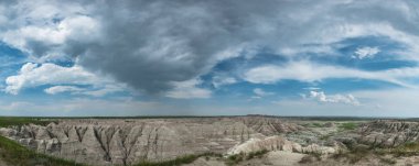 Panorama of Clouds Over Badlands Rock Formation clipart