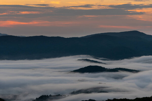 Pink Morning Light in Sky with Mountain Island Through Clouds in the Smokies