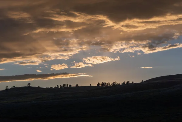 Clouds Over Silhouette of Rolling Hills in Wyoming