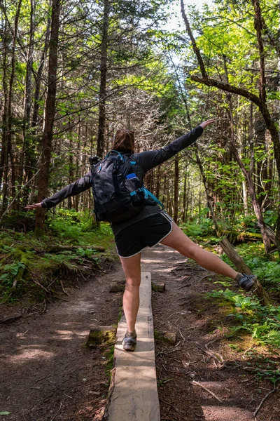 Woman Balances on Wooden Planks