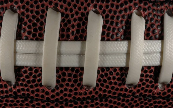 White Laces Stretch Across Football close up