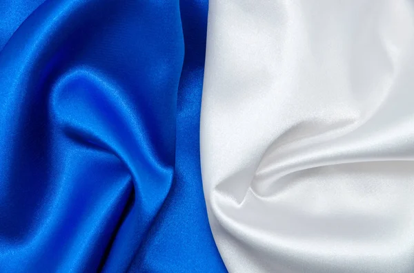 背景用白色和蓝色缎子织物 — 图库照片