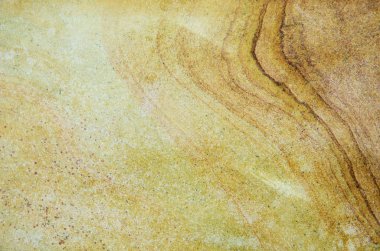 Kum taşından bir tuğlaya yakın, desenli bir arka plan.