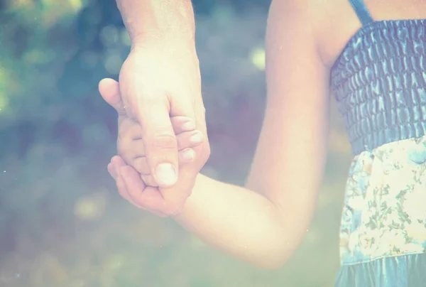 father holding  daughter hand filtered