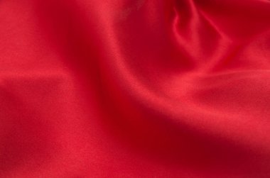 Arkaplan olarak kırmızı saten veya ipek kumaş