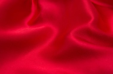 Arkaplan olarak kırmızı saten veya ipek kumaş