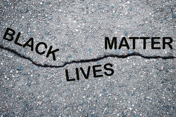 Black lives matter lettering card on asphalt background