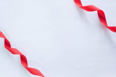 red silk ribbon on white background clipart
