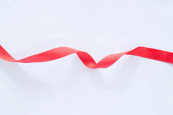 red silk ribbon on white background