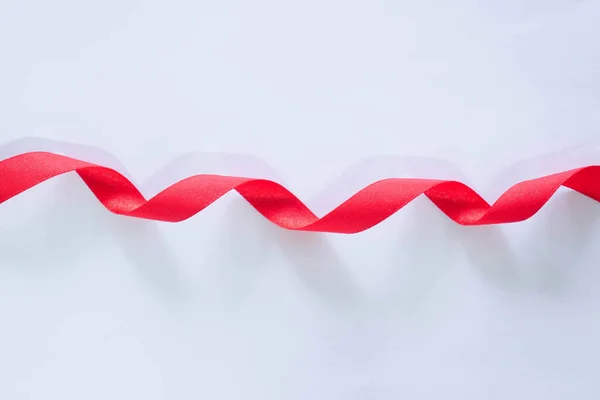 red silk ribbon on white background