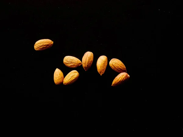 Almonds seed isolated black background. almond beans snack