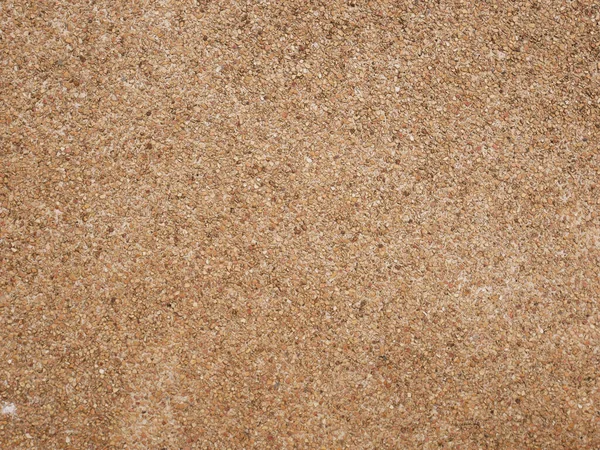 Kahverengi küçük taş duvar dokusu arka plan, zemin taşla yıkanmış, küçük kum taşından yapılmış.