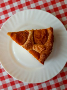 Bir dilim pasta beyaz bir plaka üzerinde.