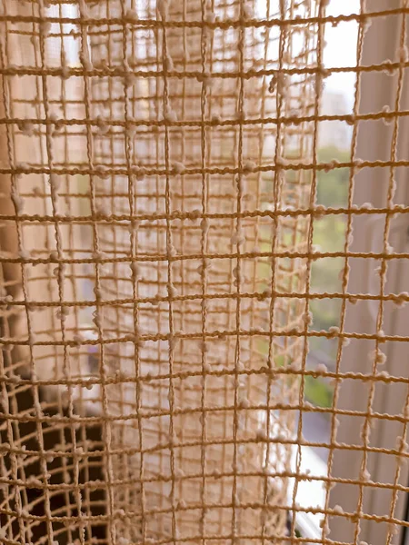 A view from the window through the net curtain.