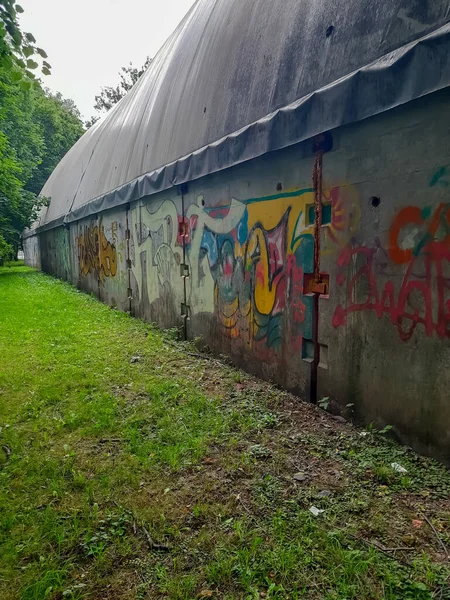 Old wall in the park with graffiti.