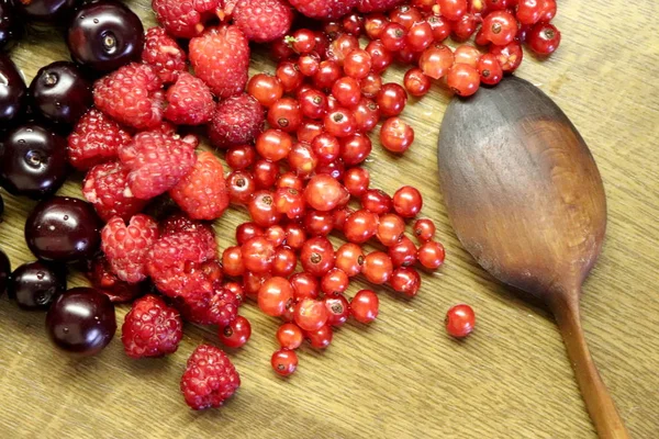 Foto di ciliegia, ribes rosso e lamponi sul tavolo di legno — Foto Stock