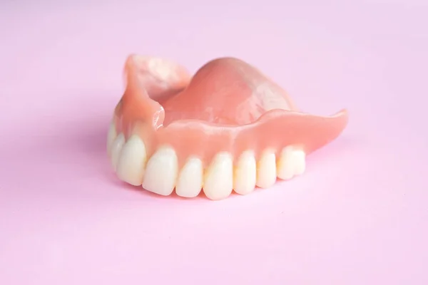 Closeup Dental Prosthesis Pink Background — Stock Photo, Image