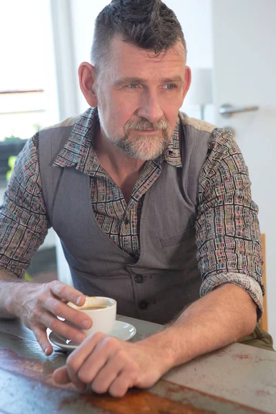 Handsome man in his 50s drinking coffee — Stock Photo, Image