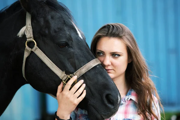 Portrait of young woman with her black horse — Stock Photo, Image