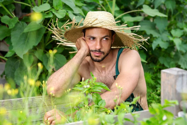 Retrato de hombre barbudo con sombrero de paja relajante en el jardín —  Fotos de Stock