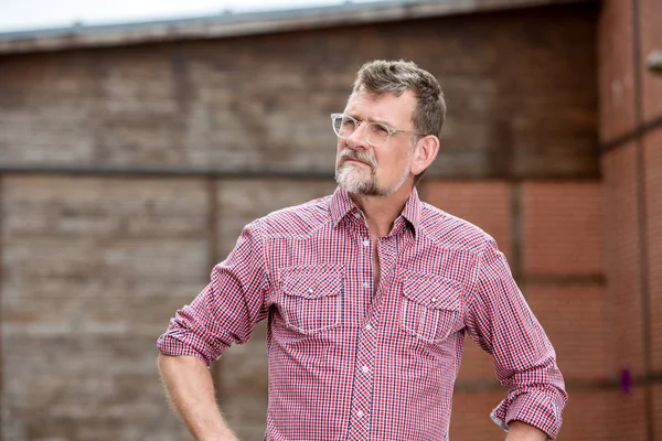 Handsome bearded man in his 50s standing outdoors — Stock Photo, Image