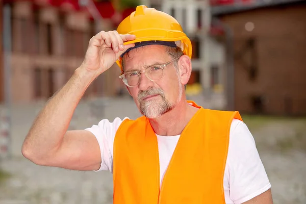 Beau travailleur dans la cinquantaine avec casque debout à l'extérieur — Photo