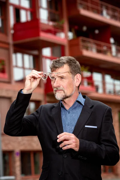 binanın önünde duran 50'li yıllarda yakışıklı işadamı